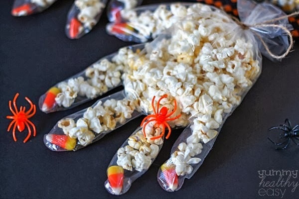 Halloween Popcorn Hands Fun Halloween craft to make with kids! Disposable gloves with candy corn fingernails, filled with popcorn. So cute!