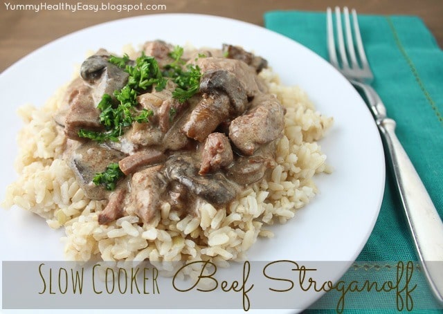 White Plate with brown rice topped with Slow Cooker Beef Stroganoff