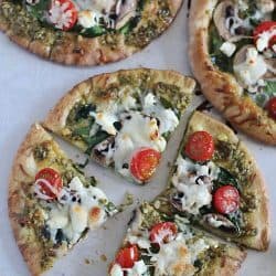 These Easy Pesto Pita Bread Pizzas use pita bread as the crusts and are spread with pesto and topped with veggies. Delicious and healthy lunch, dinner or snack!