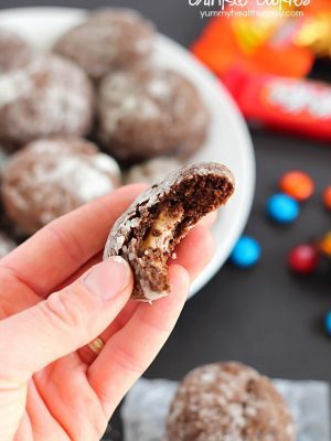 Chocolate Surprise Crinkle Cookies filled with pieces of your favorite candy inside and rolled in powdered sugar - the best way to use up any leftover candy!