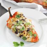 Southwestern Quinoa Stuffed Peppers Recipe - pasilla peppers filled with black beans, quinoa and spices then cooked in a flavorful tomato sauce. Vegetarian, gluten free, clean-eating and absolutely delicious!