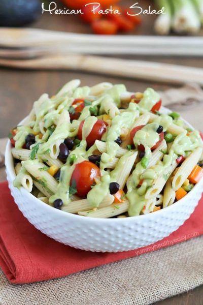A simply delicious side dish, Mexican Pasta Salad - with black beans, corn, bell pepper, cilantro, tomatoes, and an avocado dressing.