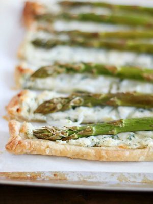 Ricotta Asparagus Tart - a crust of puff pastry, a filling of herbed ricotta, parmesan and romano cheeses, a layer of thinly sliced onions and topped with asparagus. Perfect for spring!!