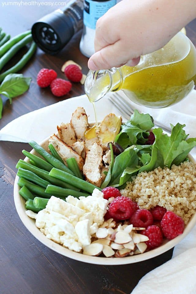 Check out this yummy salad bowl recipe full of grilled chicken, cooked quinoa, kale, raspberries, sliced almonds, feta cheese, green beans and a homemade basil vinaigrette. Super healthy and absolutely delicious! #OrganicBound #Ad