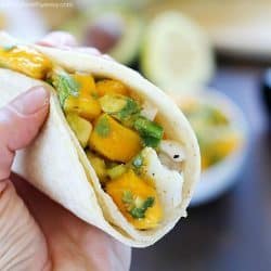 You will love these Fish Tacos with Mango Salsa! Corn tortillas filled with flaky white fish and topped with fresh mango and avocado salsa. Doesn't get better than that! #ad