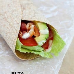 Bacon, Lettuce, Tomato & Avocado wrap on some parchment paper.