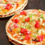 Tray with two Mexican Pizzas. Easy, yummy recipe of layered flour tortillas with a filling of refried beans, shredded chicken and salsa.