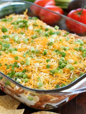 You will love this 7 Layer Bean Dip! This is my Mom's quick & easy recipe for the most requested, most popular appetizer in our family. It's perfect to bring to a party or to serve during game day!