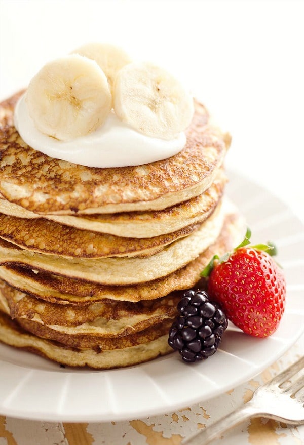 Light & Fluffy Banana Protein Pancakes are a healthy breakfast with five simple ingredients, and they're under 200 calories!