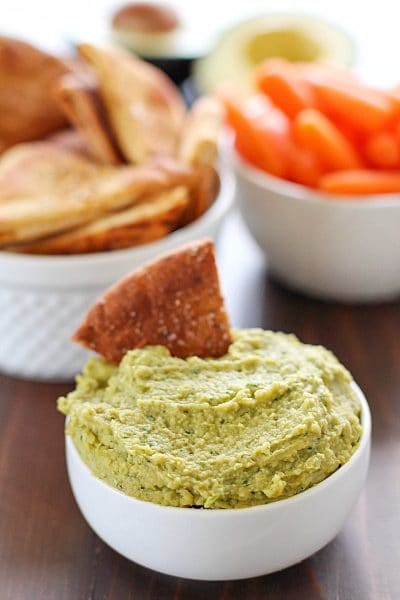 Avocado Hummus with Homemade Pita Chips - you will go crazy for the combo of avocado, garbanzo beans and spices! Dip in some easy homemade pita chips, and you have yourself a healthy, flavorful snack!
