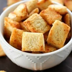 Garlic Parmesan Homemade Croutons are easy to make and cheaper than the store-bought kind! Tons of garlic parmesan flavor make these homemade croutons out of this world!!