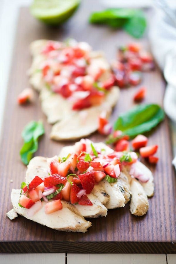 Balsamic Grilled Chicken with Strawberry Mint Salsa is a fresh spin on dinner! Fresh strawberries, mint and lime make the ideal summer topping for juicy grilled chicken!