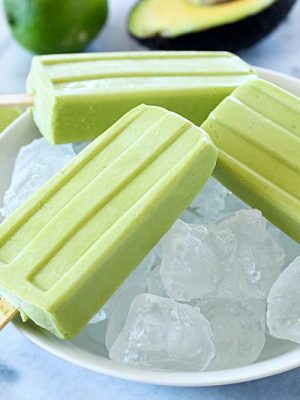 Creamy Avocado Coconut Popsicles - every bite is a tropical getaway! Who would have thought that avocado in a popsicle would be so delicious? You get a little coconut, lime and avocado in every bite of these popsicles! AD