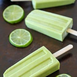 Creamy Avocado Coconut Popsicles - every bite is a tropical getaway! Who would have thought that avocado in a popsicle would be so delicious? You get a little coconut, lime and avocado in every bite of these popsicles! AD