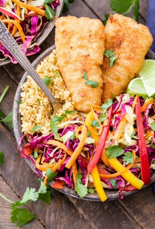 These Crispy Fish Taco Bowls with Rainbow Slaw are packed full of flavor and perfect for busy weeknights. Take your favorite whole grain and top it with crispy baked fish fillets and a crunchy cilantro honey lime flavored slaw. You’ll love these hearty taco bowls!