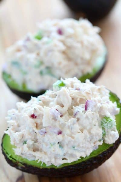 Keto Tuna Salad Stuffed Avocados aka Tuna Salad Boats on a cutting board.
