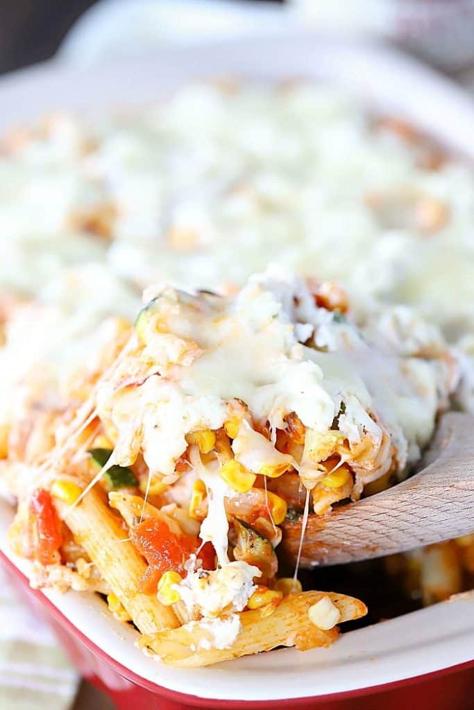 Cheese pull shot of pasta bake.