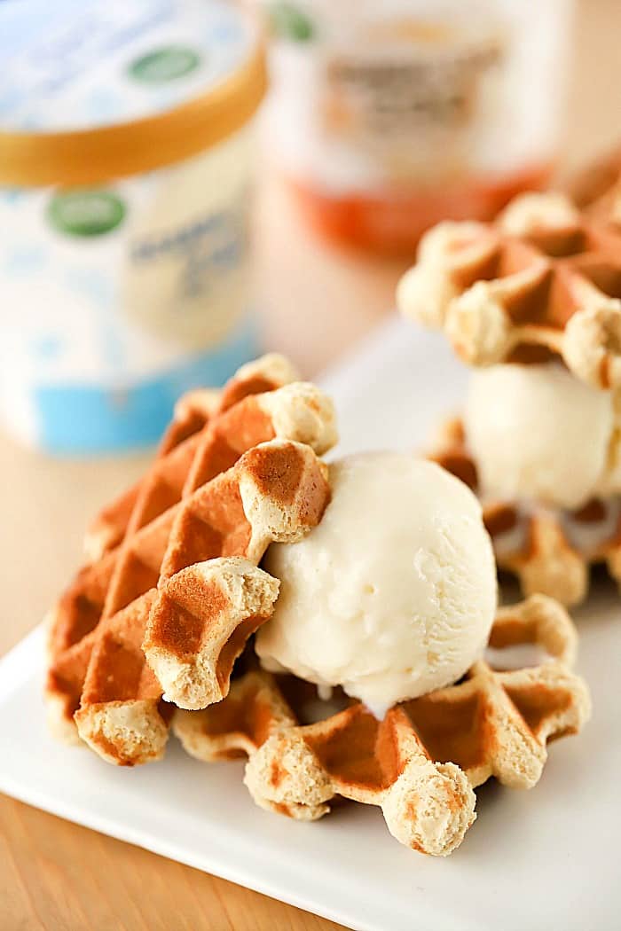 Side view close up of cookies with a scoop of ice cream in the middle.