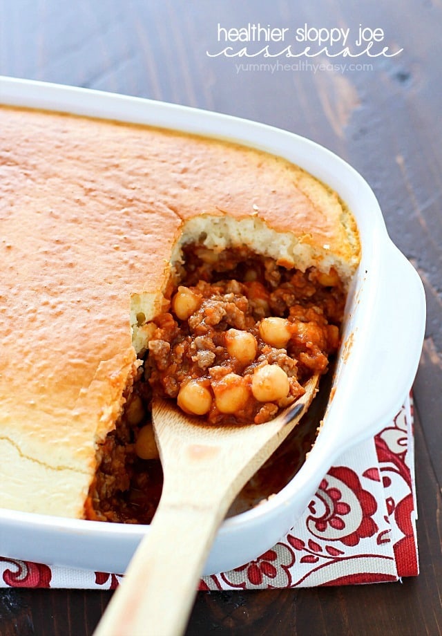Wooden spoon in a casserole dish with a healthy sloppy Joe casserole inside.