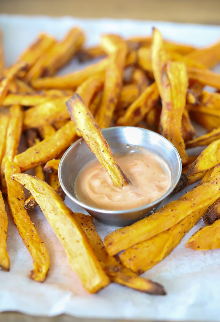 A pile of fries with fry sauce in the middle.